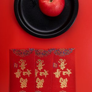 Happy Chinese New Year. Apple, angpao or red packet monetary gift for a symbol of prosperity